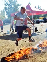 Runner leaping over fire. Photo by Alheli Curry.