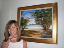 Photo of Marie Christine Briot-Connolly beside one of her paintings