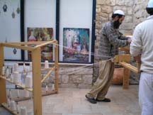 Two men working a loom