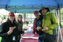 Plein Air artists eating pizza in the rain by Angela Young